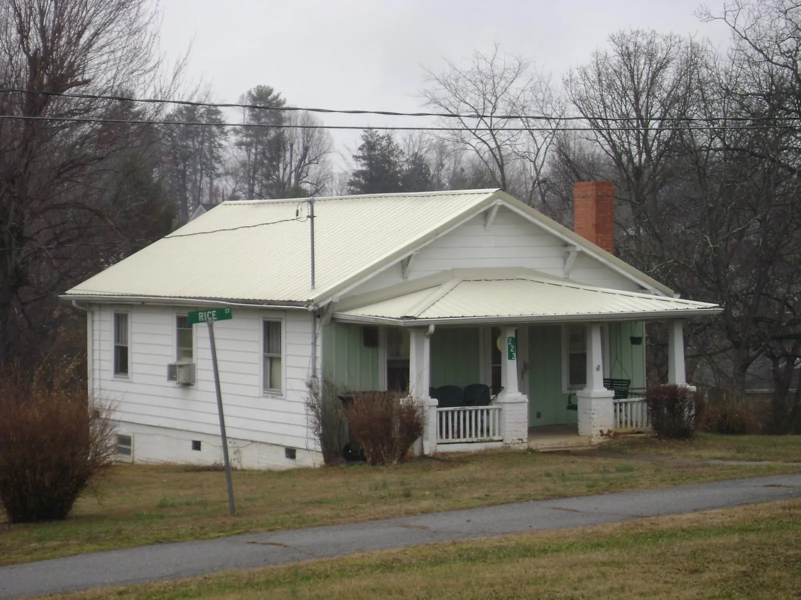 White metal roof on a craftsman bungalow at a street corner in Thaxton