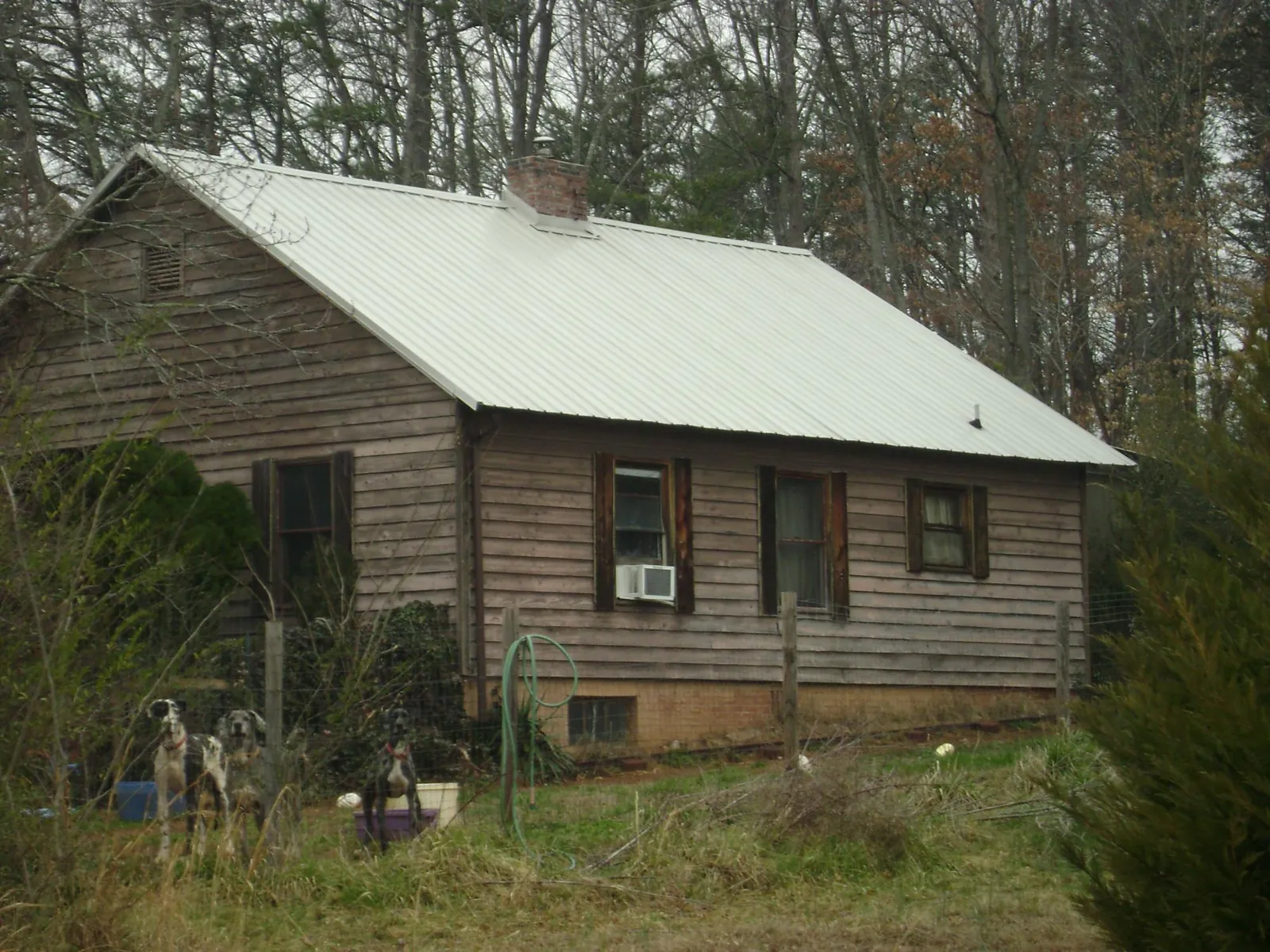 White metal roof on an old wood sided farmhouse, from a Metal Roof Installation job in Thaxton